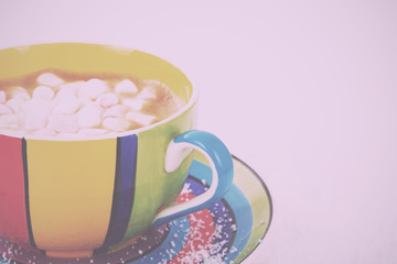 Hot chocolate in a bright colourful cup Vintage Retro Filter.