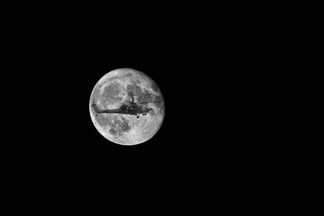 Combat helicopter on the background the moon