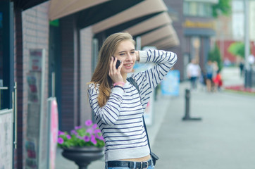 Fototapeta premium Young woman using her phone
