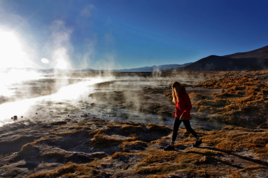 young caucasian blond woman walking near thermal water, Bolivia