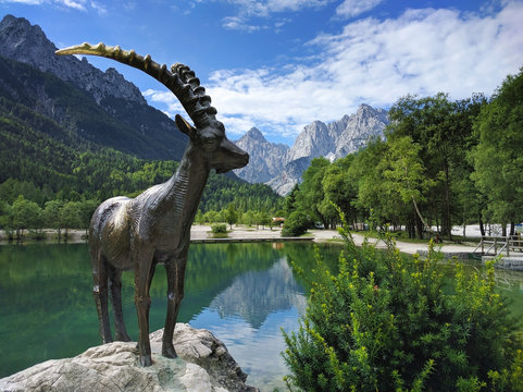 Lake Jasna and mountain goat statue closeup in Kranjska Gora, Sl