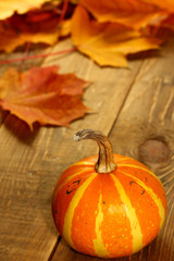 Pumpkin on the autumn table and  leaves