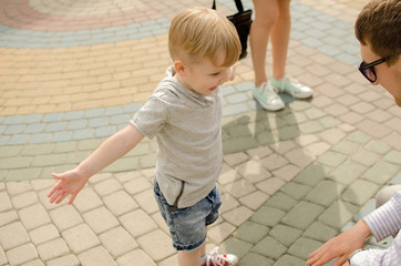 Small baby boy is having fun with his father