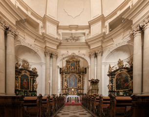 Fototapeta na wymiar Church of Saint Josef in Lesser Town (Mala Strana), Prague. The view of the altar and theinterior of the church.