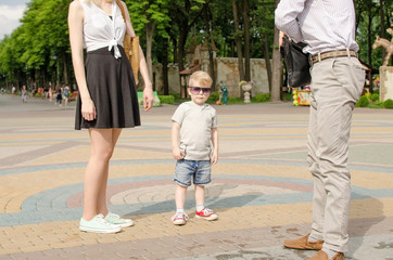 Obraz premium Young family is walking in the park 