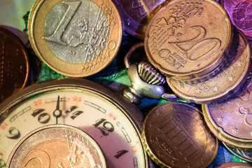vintage pocket watch and scattered coins