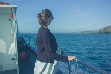 Fototapeta premium Young woman on a boat in summer