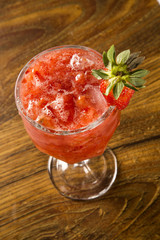 Fresh made Strawberry Caipirinha on wooden background