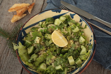 vegan healthy salad with bulgur, cucumber, avocado and crispy toast