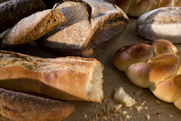 Delicious freshly baked bread on wooden background