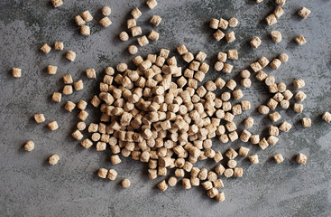 Pile of oat bran against grey background.Overhead view.