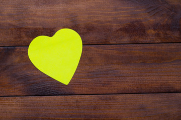 yellow heart shaped mock up frame on stylish wooden background