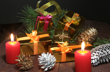 Christmas Composition with glass cognac, Gift box and candle on wooden table