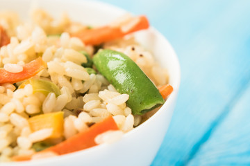Colorful rice with vegetables and chopsticks