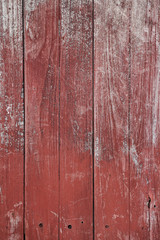 Red paint on old wooden wall background, vertical style background