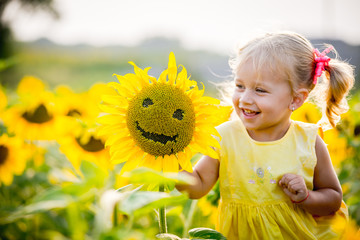 beautiful little girl in sunflowers