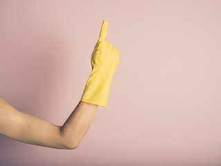 Hand in rubber glove pointing up