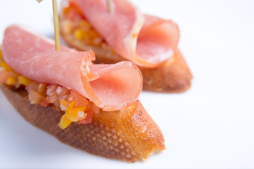 Bruschetta crostini with prosciutto and vegetables. Italian food.