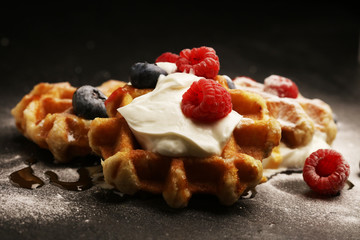 Fresh homemade waffles with ricotta served with whipped cream and berries