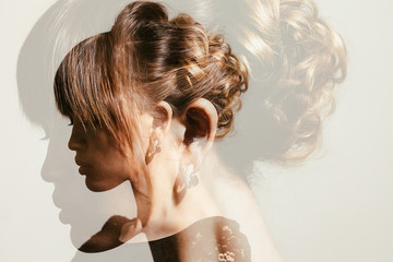 Double exposure of gorgeous bride hairdo profile view