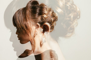 Naklejka premium Double exposure of gorgeous bride hairdo profile view