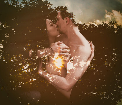 Double exposure of lovers kissing and tree silhouette in sunlight