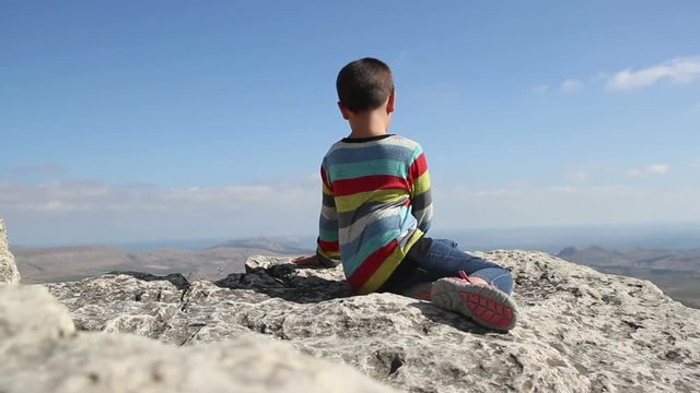 boy sits on the top