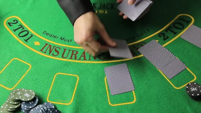 Casino table with poker player hands and playing card