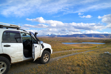 Fototapeta na wymiar Off-road tourists car on famous mountain Plateau Ukok, Altai, Ru