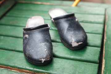 Old worn-out shoes with holes