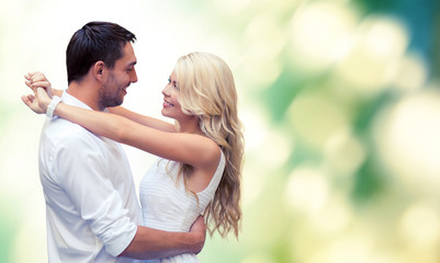 happy couple hugging over green background