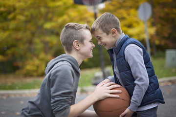 two boys with a basket ball