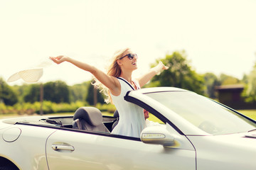 happy man and woman driving in cabriolet car - obrazy, fototapety, plakaty