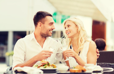 happy couple clinking glasses at restaurant lounge