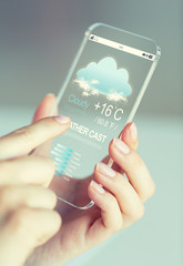 close up of hands with weather cast on smartphone