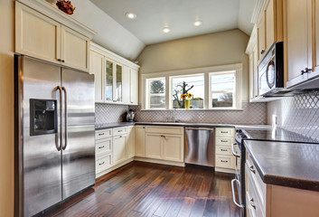 Soft beige kitchen cabinets in a kitchen room