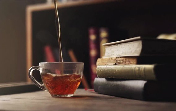 Still life pouring tea and books cinemagraph