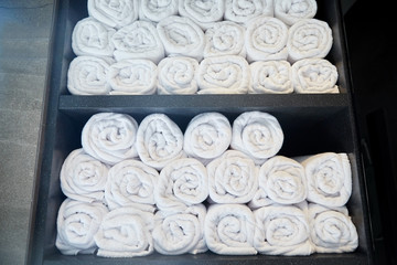 rolled white bath towels at hotel spa
