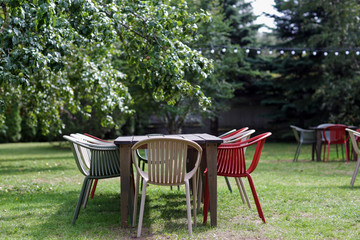 table with chairs at summer garden