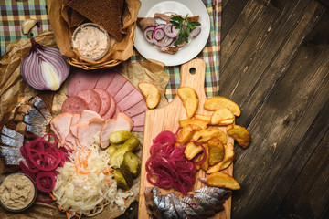 herring and snack on wooden background