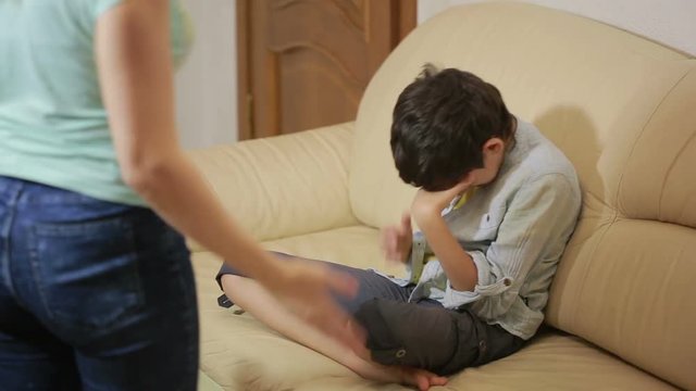 Serious mother lecturing unpleased teenager in home