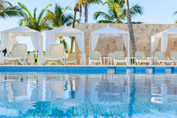 a swimming pool with sun loungers