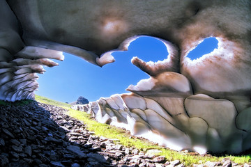 Quaint intricate mountain snow cave from inside scenery