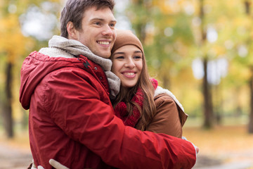 Fototapeta premium happy young couple hugging in autumn park