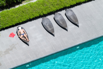 A top view of rooftop swimming pool with beds