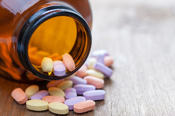 Vitamin C pills on a wooden table, supplemental diet, healthcare and wellness concept