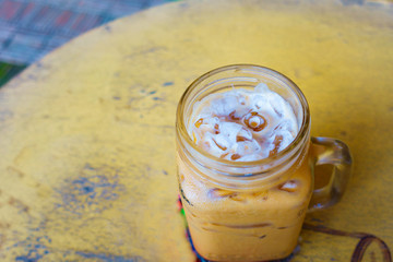 Glass of Ice Coffee On Wooden table.