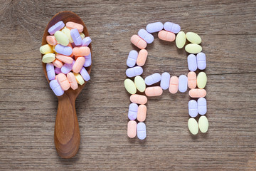 Vitamin A pills on a wooden table, supplemental diet, healthcare and wellness concept