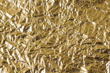 Gold wrinkled paper texture abstract background