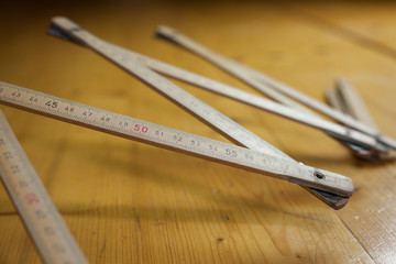 Old wood measure on the table; ready for measuring; DIY (focus o